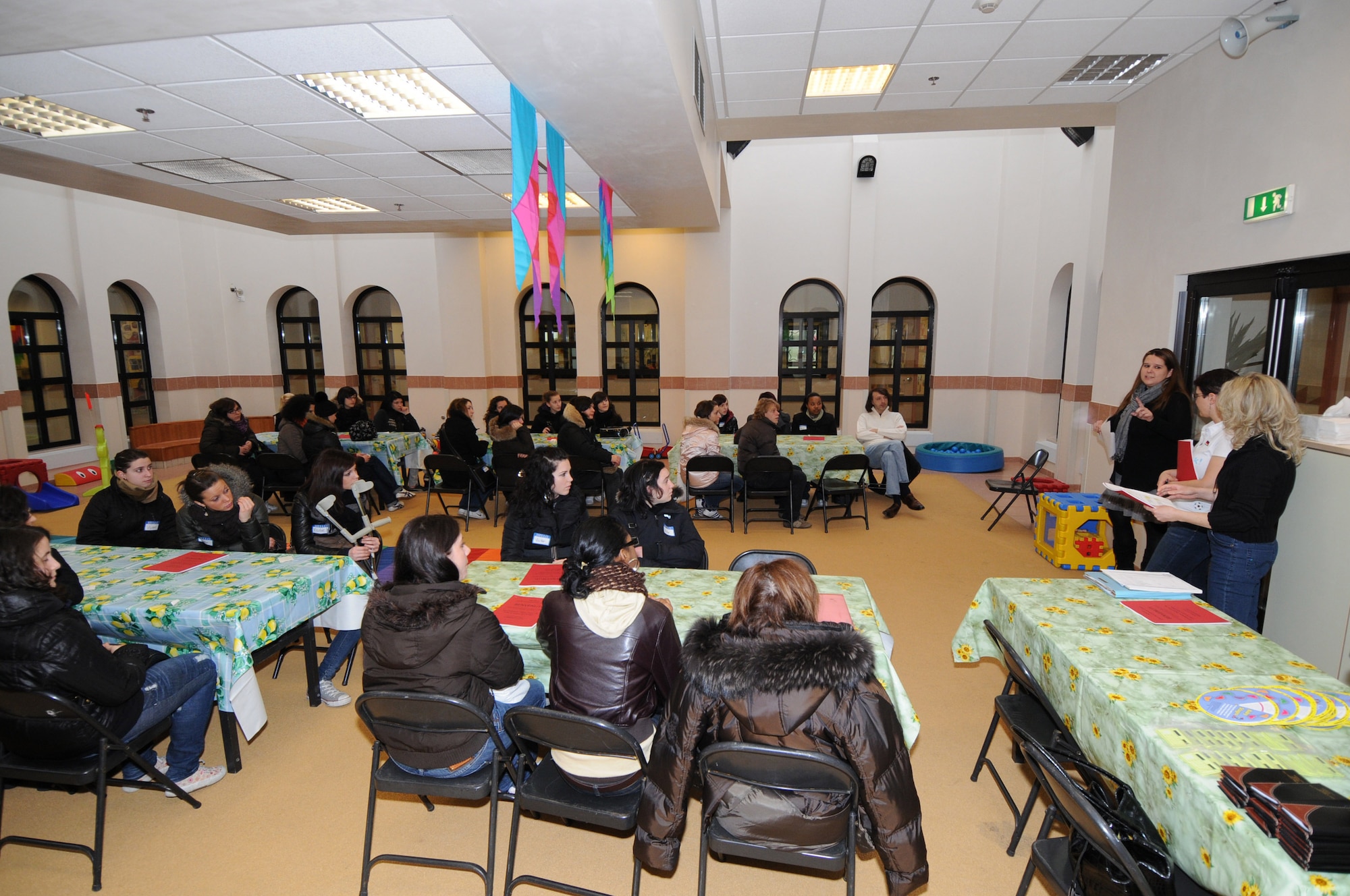 Child Development Center staff brief Italian high school students on the daily operations of the CDC located on Area F. The students came to visit the CDC Feb. 18, 2010 because they are training to become social workers. (Air Force photo/Staff Sgt. MercedesKimble L. Crossland) 