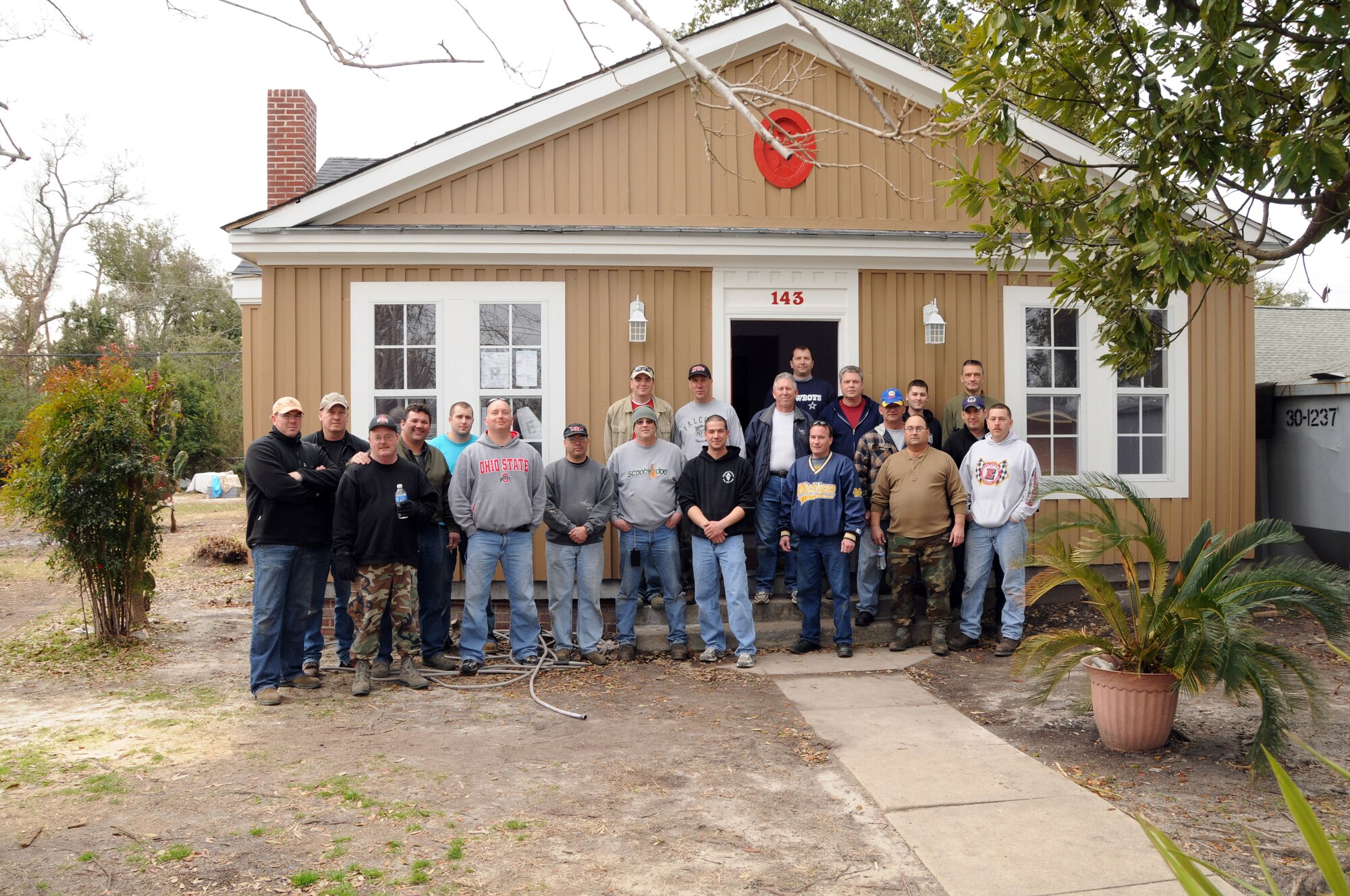 Members of the 178th Fighter Wing, Springfield, Ohio, pose for a group photo after they volunteered to help rebuild a home while deployed to the Biloxi, Miss. area, as part of an ongoing  Hope CDA project for families in need, on Feb. 6, 2010.  