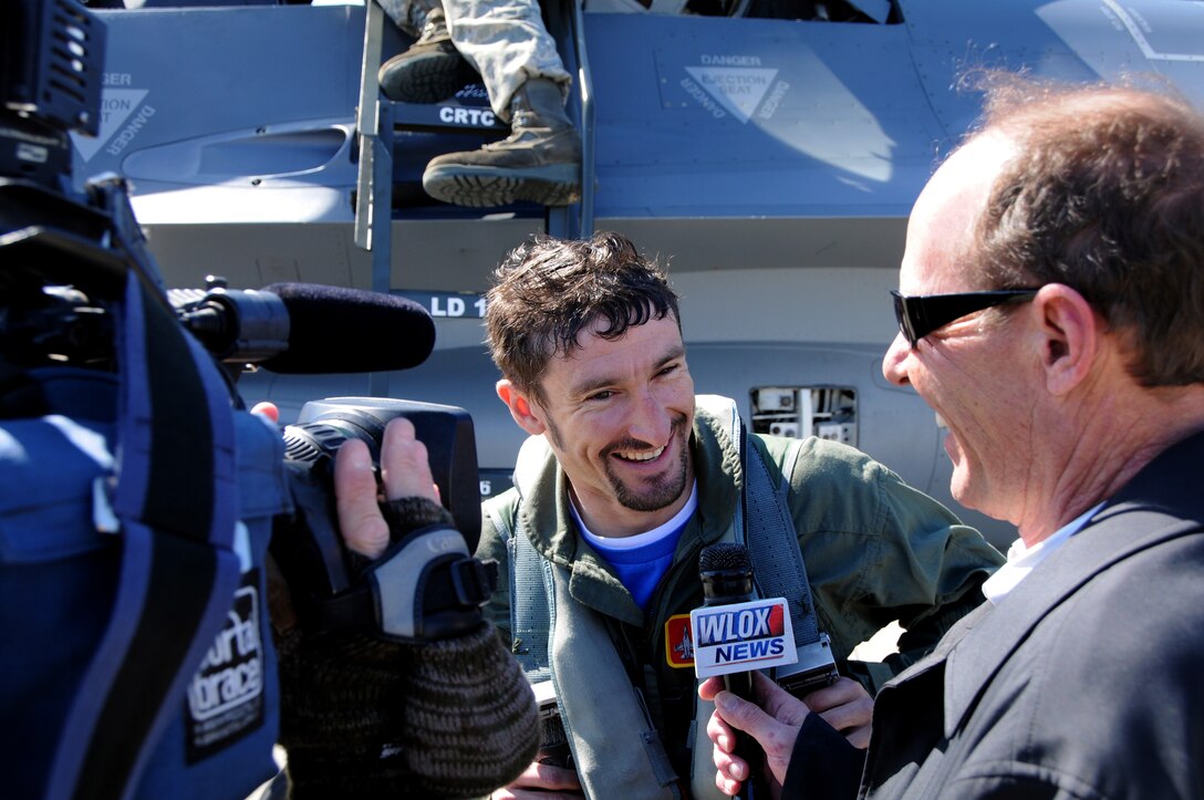 Professional motorcycle road racers Josh Hayes talks to the media after receiving an orientation flight Feb. 17, 2010 in the F-16 Fighting Falcon at Gulfport Combat Readiness Training Facility, Gulfport, Miss.  Their flight was facilitated by the 178th Fighter Wing, Springfield, OH while deployed to Gulfport, Miss.