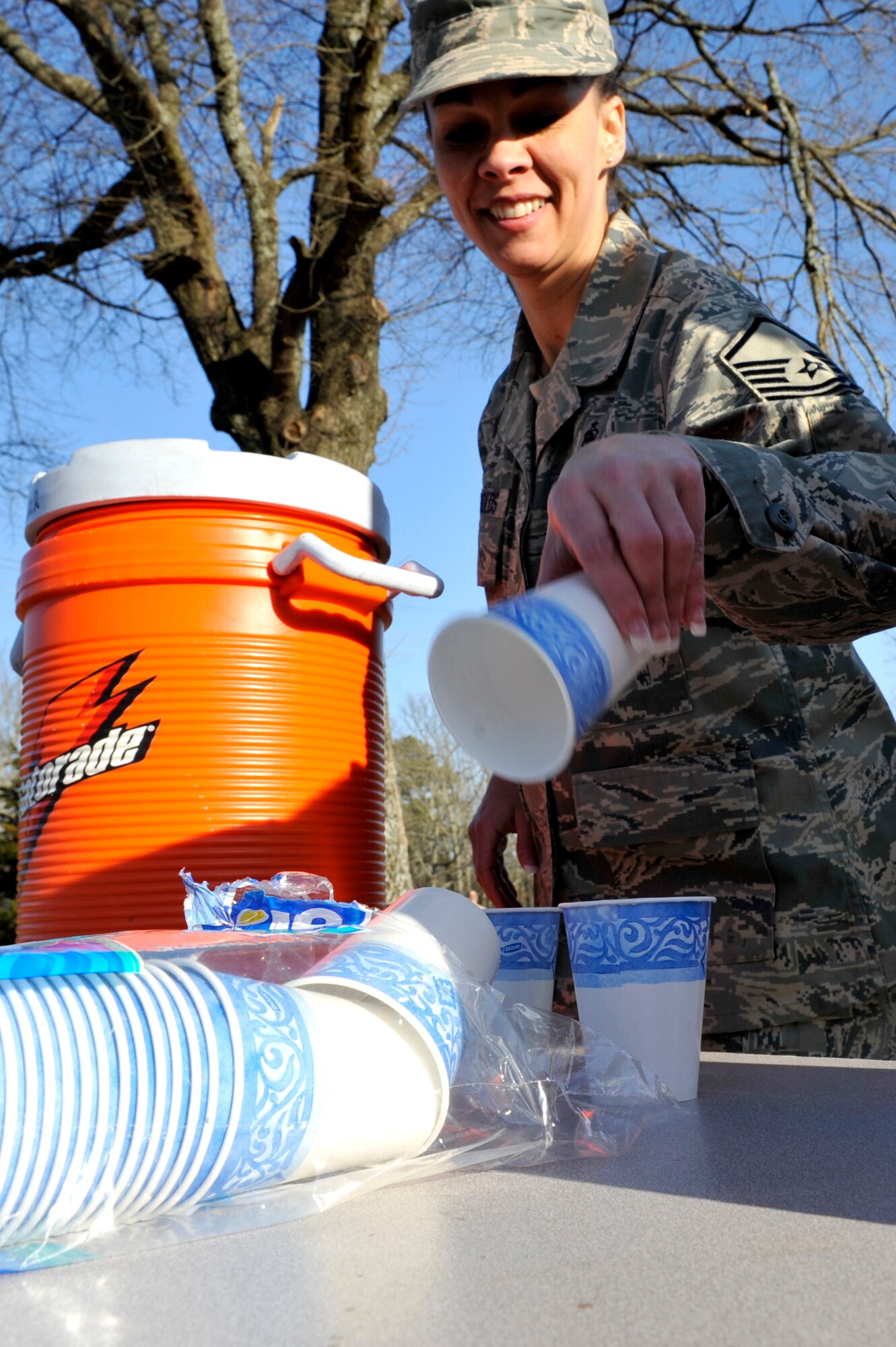 Master Sgt. Nichole Reynolds, 19th Medical Operations Squadron, prepares cold water Feb. 19  for the 5K Haiti relief runners on base. Airmen base-wide volunteered to support the runners during the race. (U.S. Air Force photo by Senior Airman Christine Clark)