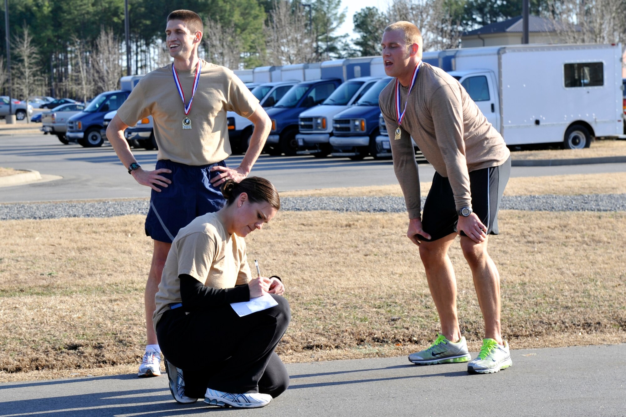 Capt. Judy Garza, 19th Force Support Squadron manpower and personal flight commander, documents Feb. 19 the run times of Chaplain (Capt.) Jeremy Gorline, 19th Airlift Wing, and Airman 1st Class Ryan Collins, 19th Operations Support Squadron, the first two finishers. Awards were given to the top three finishers for male and female categories. (U.S. Air Force photo by Senior Airman Christine Clark)