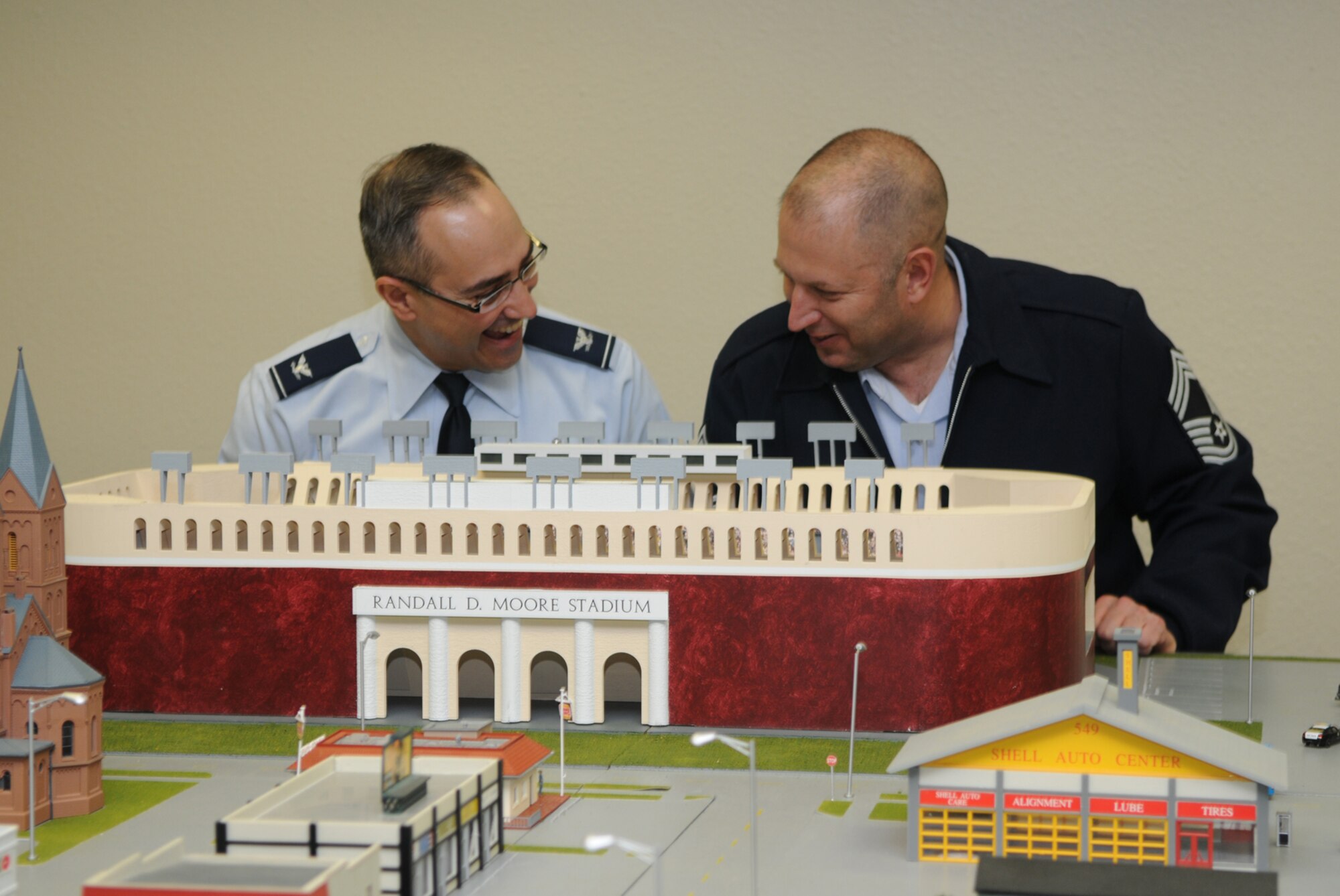 GOODFELLOW AIR FORCE BASE, Texas -- Col. Anthony Lombardo, 17th Training Group commander, and Chief Master Sgt. Robert Puhl, 17 TRG superintendent, laugh at the details put into the Randall D. Moore Stadium in Mooresville, following the ribbon-cutting ceremony for the new Command and Control Simulations Trainer at the Louis F. Garland Department of Defense Fire Academy, Feb. 22, 2010. This ribbon-cutting marks the expansion in training for DOD personnel from on-base emergency management to the National Incident Management System. (U.S. Air Force Photo/Airman 1st Class Clayton Lenhardt)