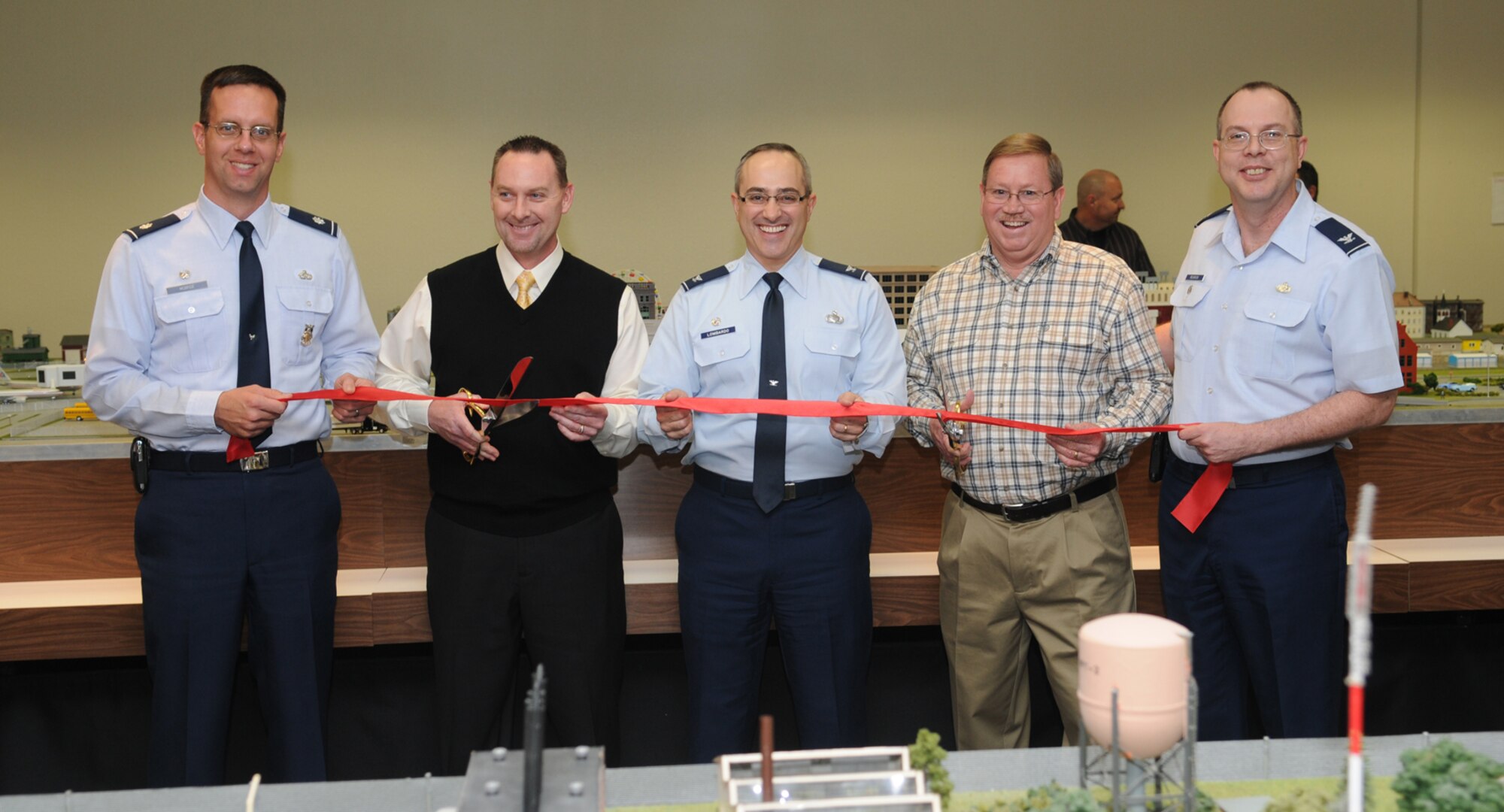 GOODFELLOW AIR FORCE BASE, Texas -- Goodfellow AFB and Randolph AFB personnel take part in the ribbon-cutting ceremony for the new Command and Control Simulations Trainer at the Louis F. Garland Department of Defense Fire Academy, Feb. 22, 2010. From the left: Lt. Col. Jeffrey McBride, 312th Training Squadron commander, Sam Sprouse, 312 TRS instructor, Col. Anthony Lombardo, 17th Training Group commander, Bryan Fryer, 902nd Mission Support Group trainer development project manager, Randolph AFB, Texas, and Col. David Rearick, 17th Training Wing vice commander. (U.S. Air Force Photo/Airman 1st Class Clayton Lenhardt)