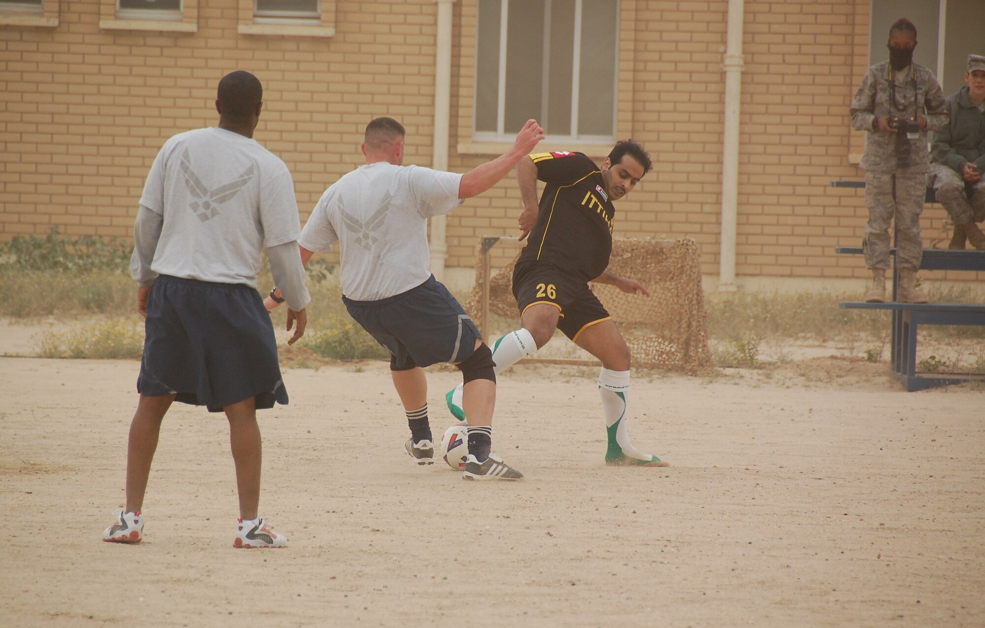 U.S. Air Force Maj. David Decoursey, middle, steals the ball from a host nation Coalition member during a soccer scrimmage Feb. 24, 2010 at an air base in Southwest Asia. The 386th Air Expeditionary Wing’s team hopes to gain the championship title from the undefeated host nation team at a later date. (U.S. Air Force photo by Staff Sgt. Lindsey Maurice/Released)