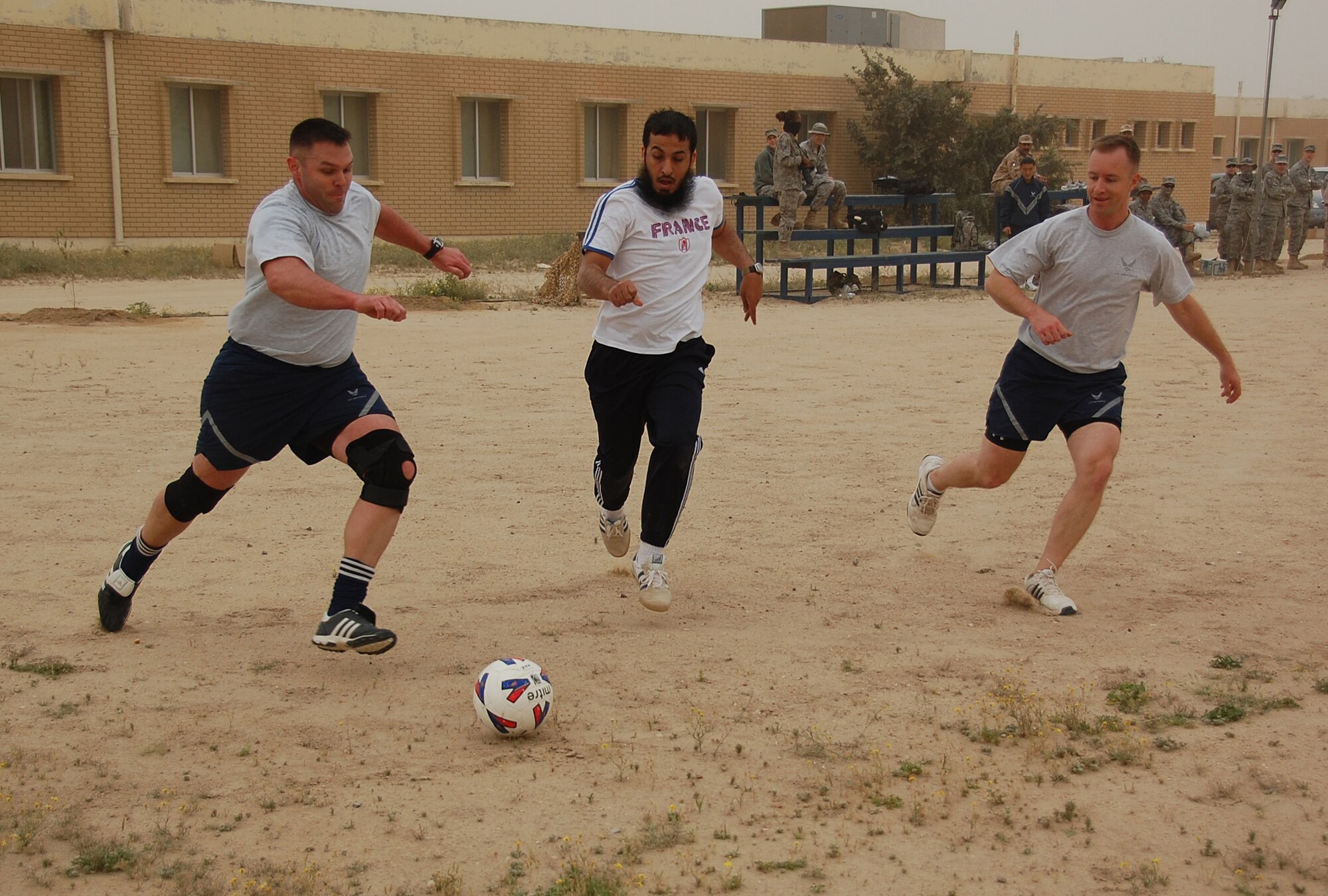 U.S. Air Force Maj. David Decoursey, left, defends against a host nation Coalition member during a soccer scrimmage Feb. 24, 2010 at an air base in Southwest Asia. The 386th Air Expeditionary Wing’s team hopes to gain the championship title from the undefeated host nation team at a later date. (U.S. Air Force photo by Staff Sgt. Lindsey Maurice/Released)