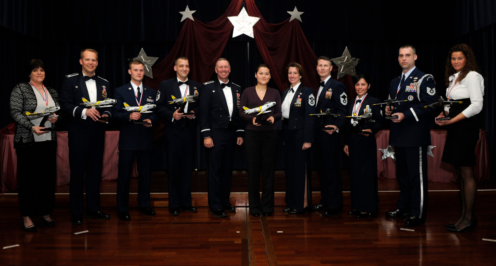 SPANGDAHLEM AIR BASE, Germany -- The 2009 52nd Fighter Wing Annual Award winners stand center stage with Col. Tip Wight (left of center), 52nd FW commander, and Chief Master Sgt. Sandi Miller (right of center), 52nd FW command chief, Feb. 20 at Club Eifel.  The individuals competed against nominees from across the wing for top honors.  (U.S. Air Force photo/Airman 1st Class Staci Miller)