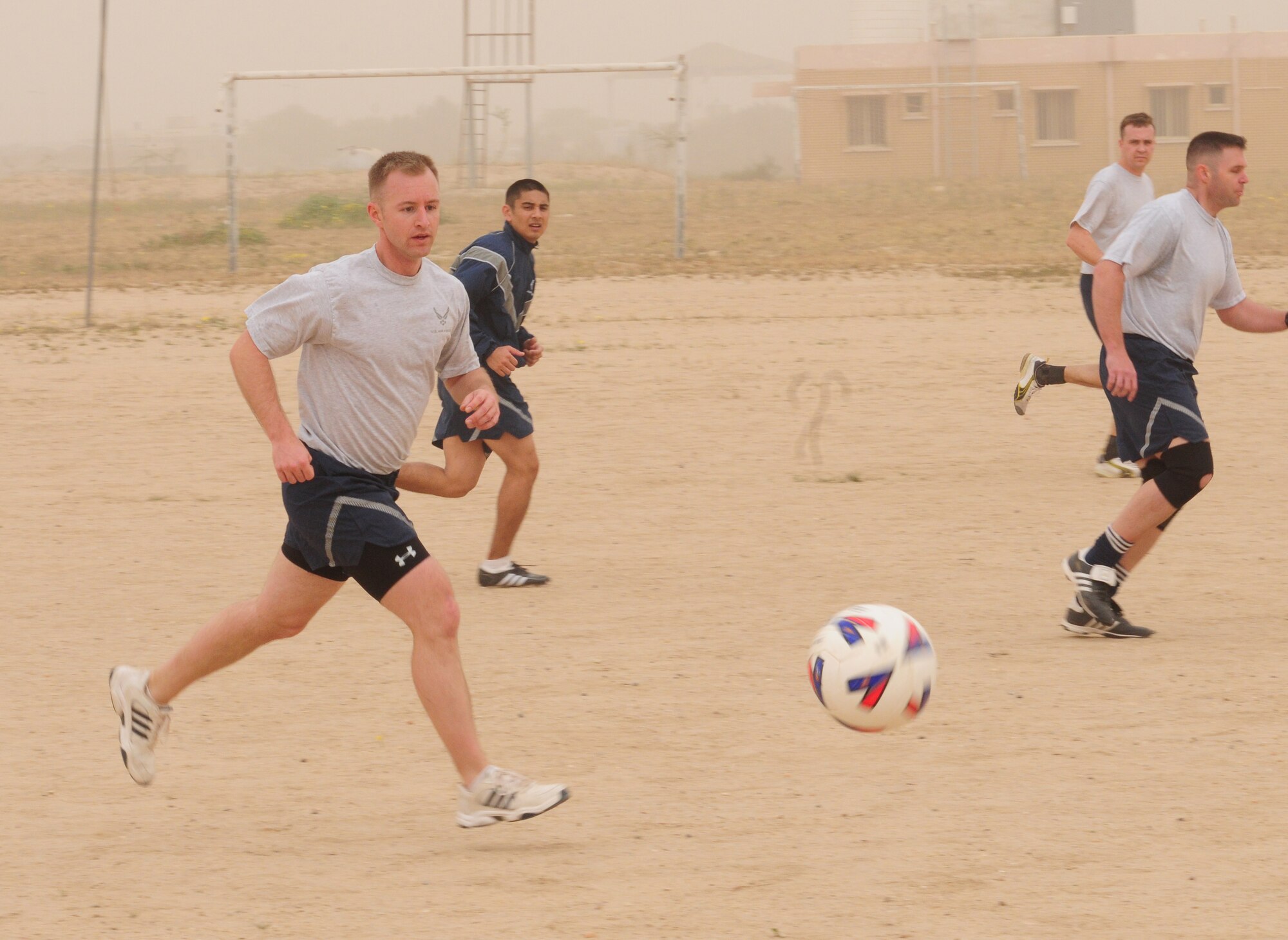 U.S. Air Force Capt. Matthew Olson hustles to the ball during a soccer scrimmage Feb. 24, 2010 at an air base in Southwest Asia. The 386th Air Expeditionary Wing’s team hopes to gain the championship title from the undefeated host nation team at a later date. (U.S. Air Force photo by Staff Sgt. Lakisha A. Croley/Released)