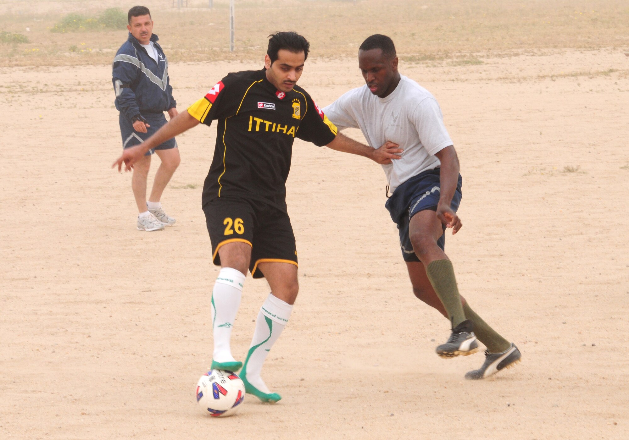 U.S. Air Force Staff Sgt. Chaderton Adams, right, positions himself on defense against a Coalition military counterpart during a host base soccer scrimmage Feb. 24, 2010 at an air base in Southwest Asia. The 386th Air Expeditionary Wing’s team hopes to gain the championship title from the undefeated host nation team at a later date. (U.S. Air Force photo by Staff Sgt. Lakisha A. Croley/Released)