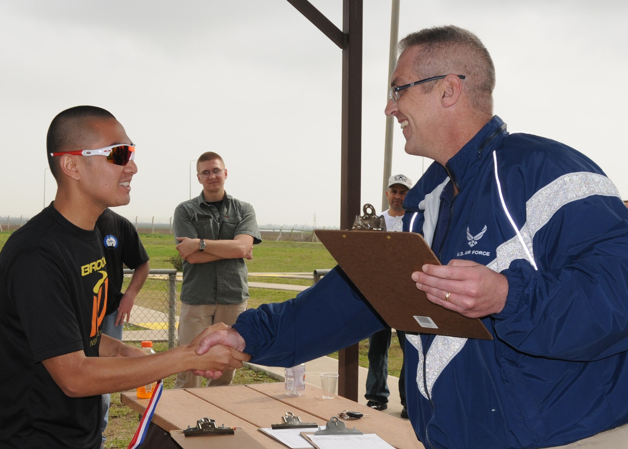 Mr. Ernest Fasoldt, 39th Force Support Squadron, hands Senior Airman Berlin Aniciete, 39th Logistics Readiness Squadron, the first place medal in the 34 and under men’s category during Incirlik’s first Winterathlon Saturday, Feb. 20, 2010.  The Winterathlon started and finished at the skeet range.  (U.S. Air Force photo/Senior Airman Ashley Wood) 