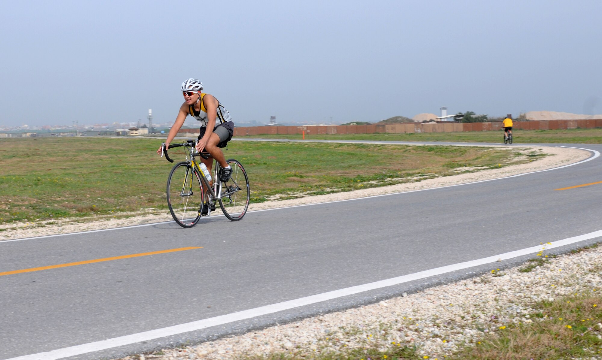 Senior Airman Berlin Aniciete, 39th Logistics Readiness Squadron, races to the finish line after running a 10K and finishing up the 20K bike ride during Incirlik’s first Winterathlon Saturday, Feb. 20, 2010.  The event lasted close to three hours giving each participant time to shoot at the skeet range.   (U.S. Air Force photo/Senior Airman Ashley Wood) 
