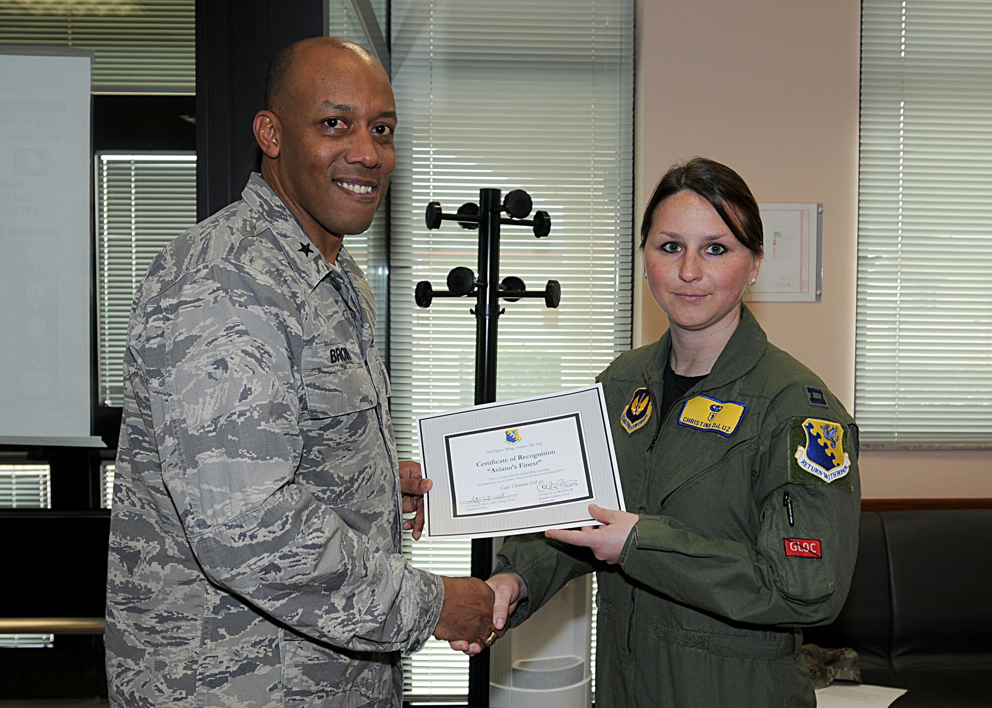 Brig. Gen. C.Q. Brown Jr., 31st Fighter Wing commander, congratulates Capt. Christina DaLuz, 31st Aerospace Medicine Squadron, on her selection as one of Aviano's Finest.  (U.S. Air Force photo/Senior Airman Tabitha M. Mans)