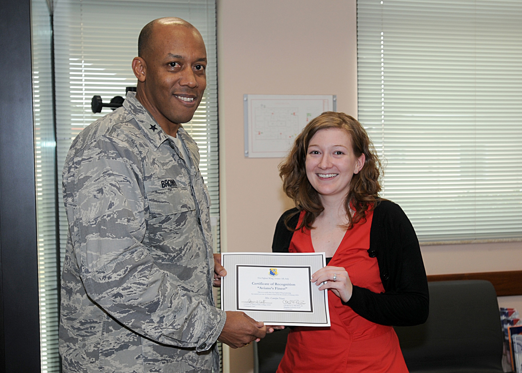 Brig. Gen. C.Q. Brown Jr., 31st Fighter Wing commander, congratulates Carolyn Neace, 31st Aerospace Medicine Squadron, on her selection as one of Aviano's Finest.  (U.S. Air Force photo/Senior Airman Tabitha M. Mans)