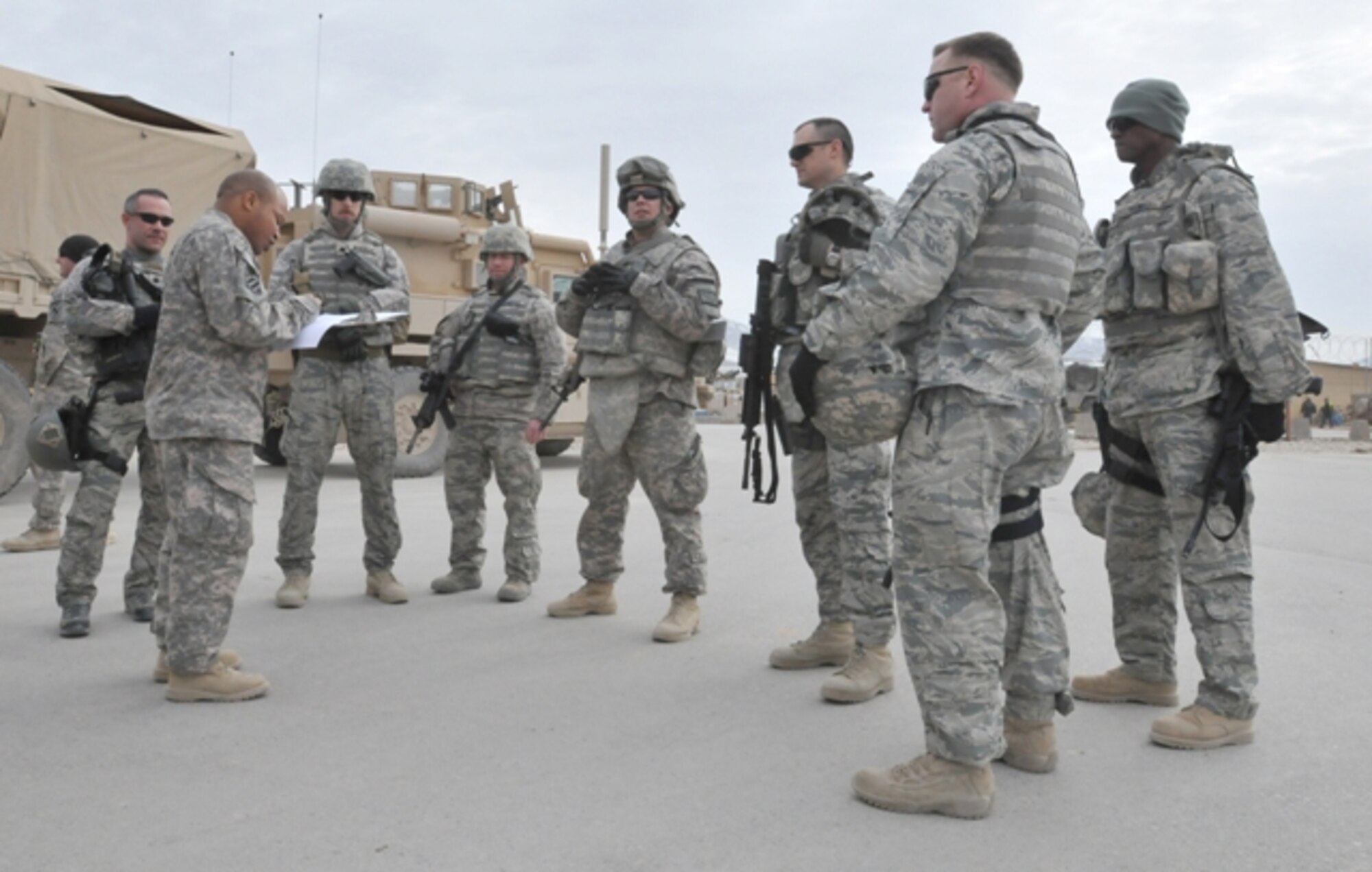BALKH PROVINCE, Afghanistan – U.S. Air Force Chief Master Sgt. Terrell Thomas, 955th Air Expeditionary Squadron superintendent (far left), U.S. Air Force Maj. Bill Skinner, 955th Air Expeditionary Squadron deputy commander, and U.S. Air Force Master Sgt. Gordon Comerford, 955th Air Expeditionary Squadron first sergeant, along with other International Security Assistance Force members check in with their convoy commander before traveling from Mazar-e Sharif to Camp Spann in northern Afghanistan. The 955th AES leadership traveled from Bagram Airfield, Afghanistan on Feb. 17 to meet with Airmen from the 955th AES stationed in Regional Command-North. (U.S. Air Force photo by/Senior Airman Andrew Caya)
