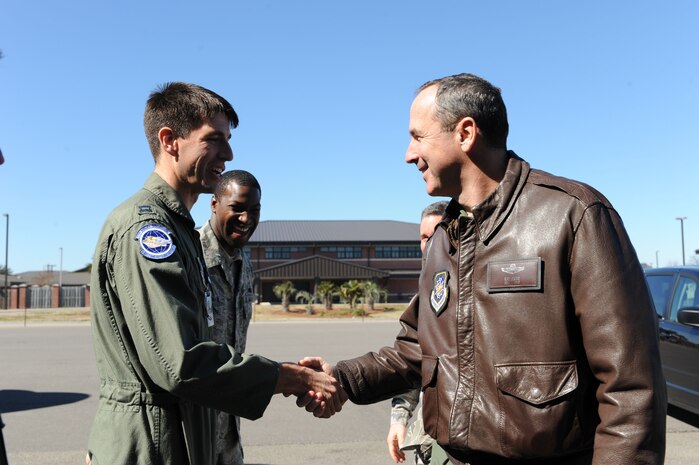 Capt. Matthew Tinker and Staff Sgt. Clinton Coleman greet Gen. Raymond Johns before he departed Joint Base Charleston Feb. 18. The general made a stop at Charleston where he was briefed on the base's Haiti stage operation before flying to Haiti for an operational assessment of the humanitarian mission there. General Johns is the commander of Air Mobility Command, Captain Tinker is a pilot with the 17th Airlift Squadron and Sergeant Coleman is the NCO in charge of wing protocol. (U.S. Air Force photo/Senior Airman Katie Gieratz)