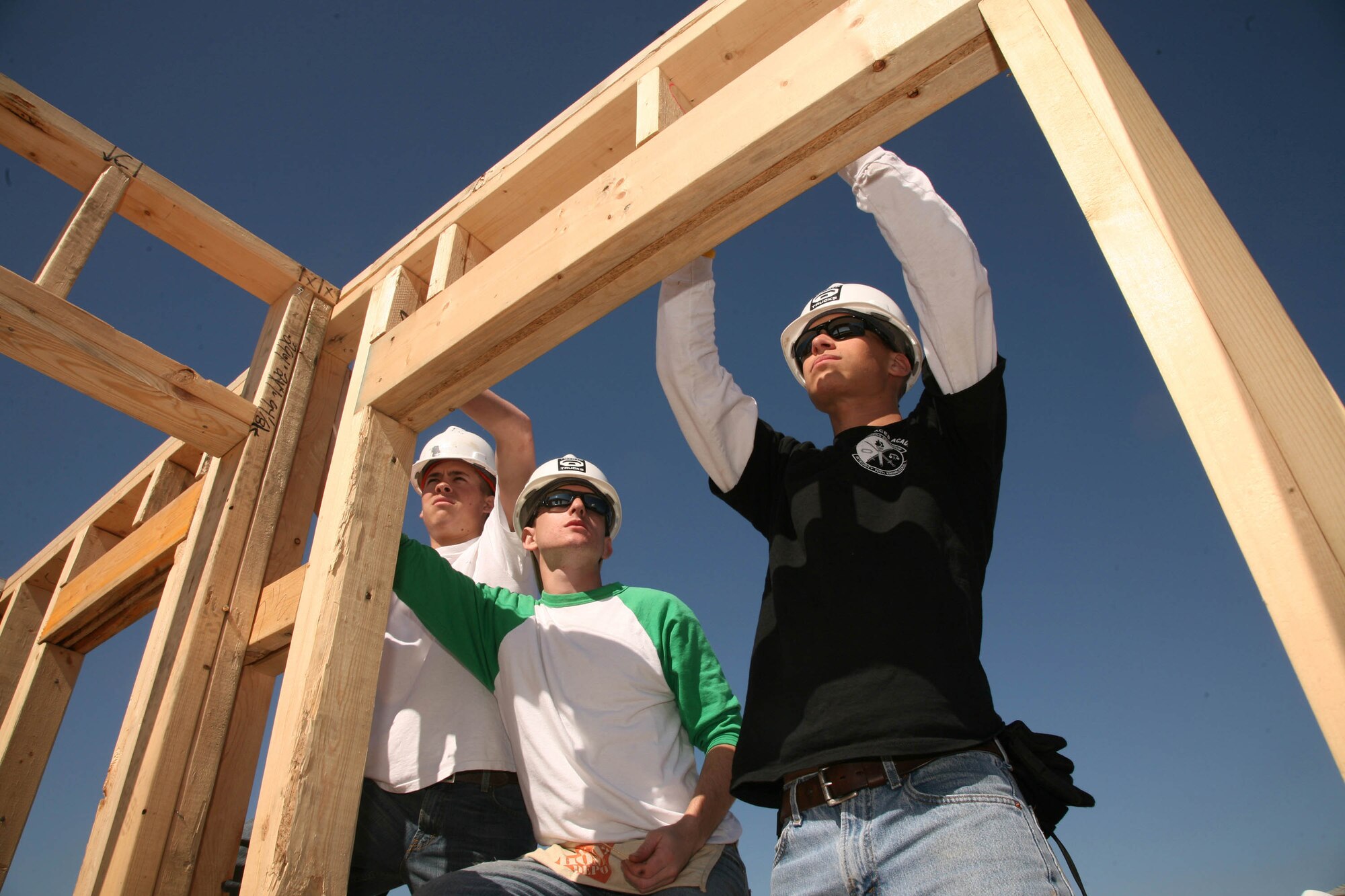 (Left to right) Airmen Greg Graham, Brett Huette and Branden Hartlove, all with the 343rd Training Squadron, take measurements while framing a Habitat for Humanity house Feb. 6. The Airmen are part of the 343rd TRS SHIELD program, which emphasizes character building. (U.S. Air Force photo/Robbin Cresswell)
