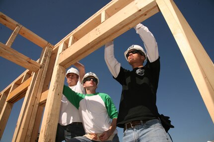 (Left to right) Airmen Greg Graham, Brett Huette and Branden Hartlove, all with the 343rd Training Squadron, take measurements while framing a Habitat for Humanity house Feb. 6. The Airmen are part of the 343rd TRS SHIELD program, which emphasizes character building. (U.S. Air Force photo/Robbin Cresswell)