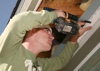 Airman Kyle Dolloff, 343rd Training Squadron, works on a Habitat for Humanity house Feb. 6. The volunteer project is part of the 343rd TRS SHIELD (Service, Honor, Integrity, Excellence and Leadership Development) program. (U.S. Air Force photo/Robbin Cresswell) 