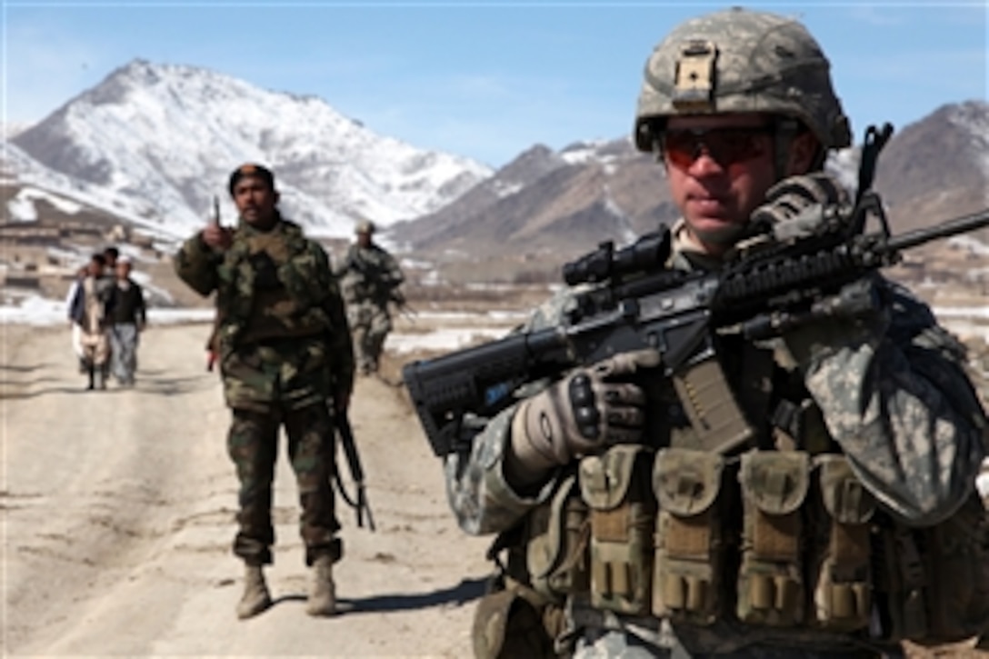 A U.S. Army soldier with Alpha Company, 1st Battalion, 503rd Infantry Regiment, 173rd Airborne Brigade Combat Team conducts a patrol with a platoon of Afghan National Army soldiers in the village of Yawez, Wardak province, Afghanistan, on Feb. 17, 2010.  