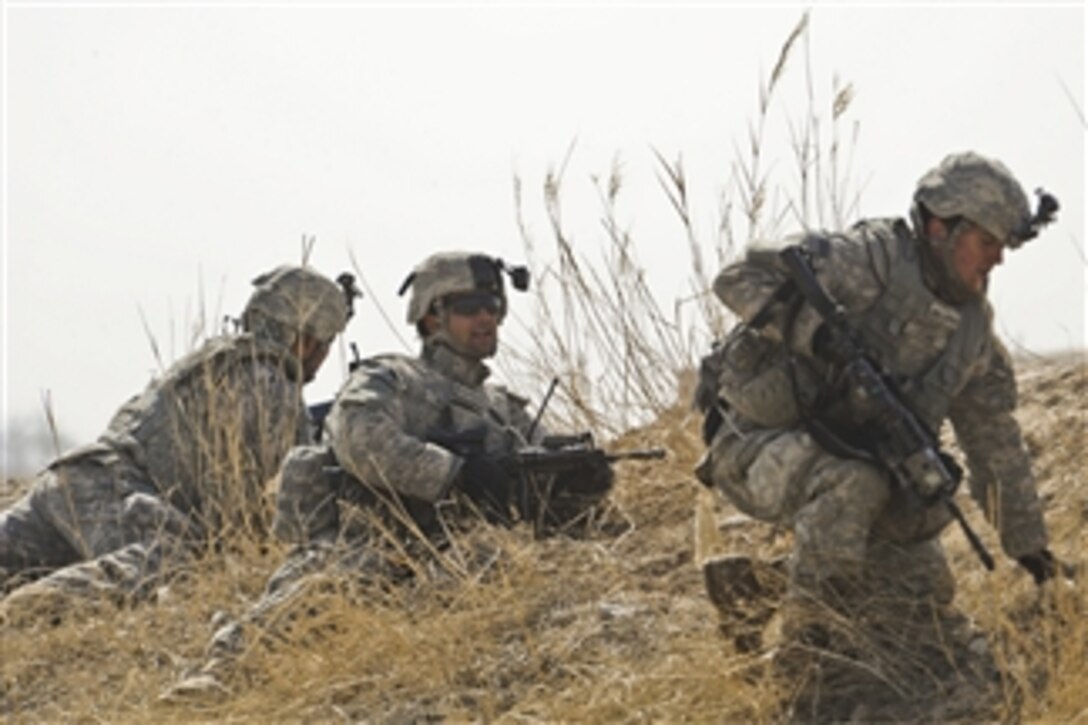 U.S. Army Spc. Jered Nelson, Sgt. Guillermo Garcia and Spc. David Schank, with Alpha Company, 1st Battalion, 17th Infantry Regiment, take cover behind a berm as they engage in a small arms firefight with insurgents during Operation Helmand Spider in Badula Qulp, Helmand province, Afghanistan, on Feb. 17, 2010.  