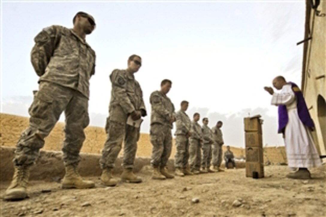 U.S. Army Capt. Carl Subler, right, a chaplain, celebrates Catholic Mass for soldiers at an abandoned compound during Operation Moshtarak in Badula Qulp in Helmand province, Afghanistan, Feb. 21, 2010. The soldiers are assigned to Company A, 1st Battalion, 17th Infantry Regiment.