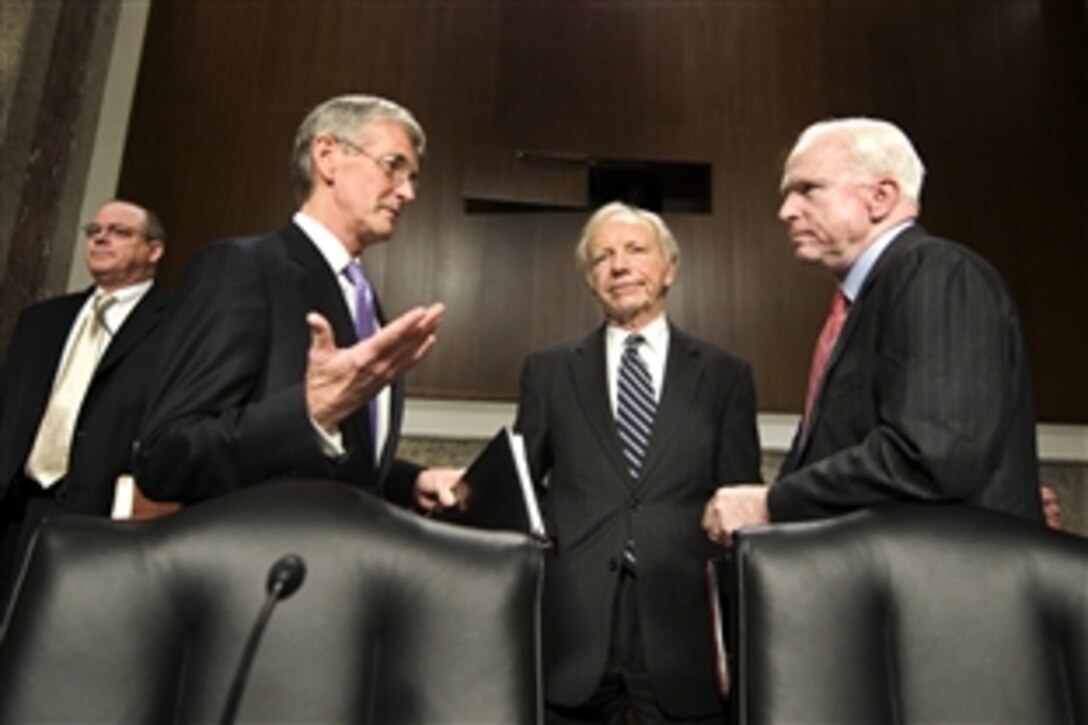 Army Secretary John McHugh talks with Sens. John McCain, R-Ariz., right, and  Joseph Lieberman, D-Conn., center, before the Senate Armed Services Committee hearing on the Army's fiscal year 2011 budget in Washington, D.C., Feb. 23, 2010.  