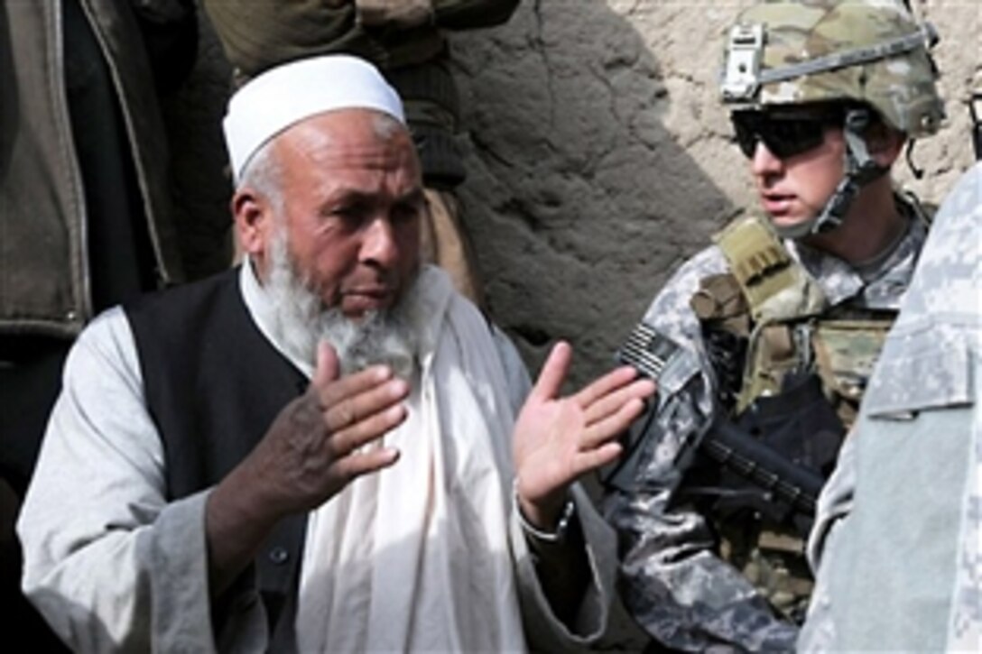 U.S. Army 1st Lt. Gabriel C. Dearman meets with an elder in the village of Chowgam in the Monagai district of eastern Afghanistan’s Kunar province, Feb. 20, 2010. The two are discussing projects the villagers might need, such as improved water systems or retaining walls.