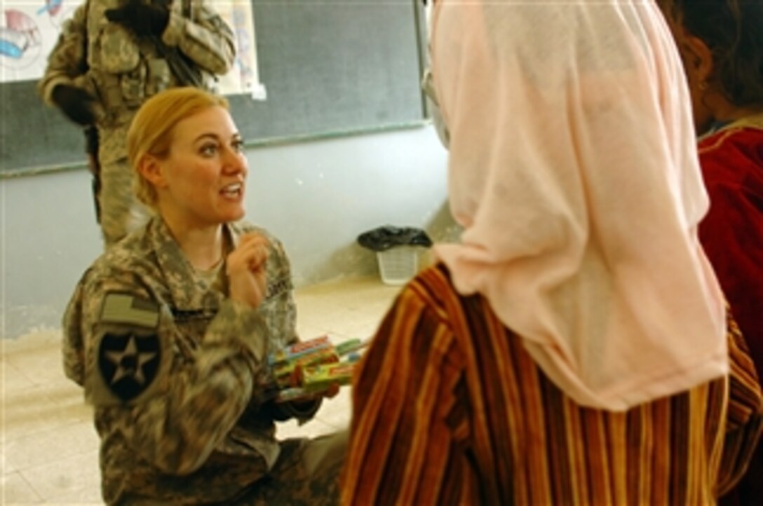 U.S. Army Capt. Marry Noland (left), a preventive medical officer, talks to local Iraqi children on the importance of washing their hands and brushing their teeth at the first Tripartite Medical Civil Action Project in Albu Gade, Iraq, on Feb. 9, 2010.  U.S. soldiers worked alongside Iraqi and Peshmerga army soldiers to provide local Iraqi residences with medical attention.  