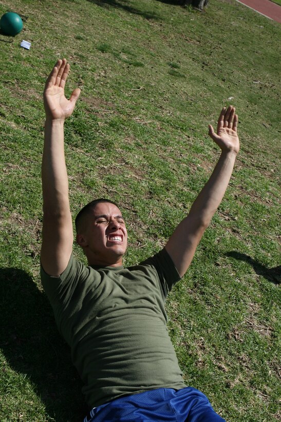 Lance Cpl. Emanuel Patino, an airspeed clerk with Marine Aviation Logistics Squadron 16, does crunches during the Ultimate Warrior Challenge, Feb. 24. Any Marine or sailor interested in participating is welcome to attend every Wednesday.