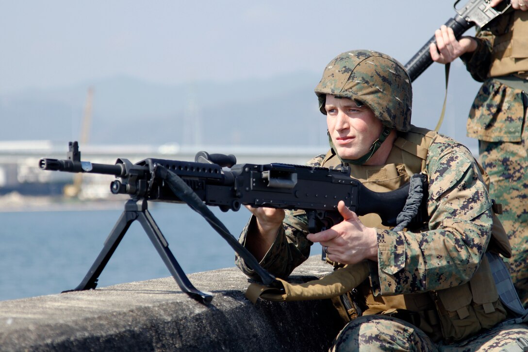A Marine Wing Support Squadron 171 Marine stands watch on the seawall here to protect the station against further attacks during Exercise Total Shield 2010 Feb. 24. Exercise Total Shield was designed to test the station’s ability to continue its normal support operations while successfully defending itself against terrorist attacks.