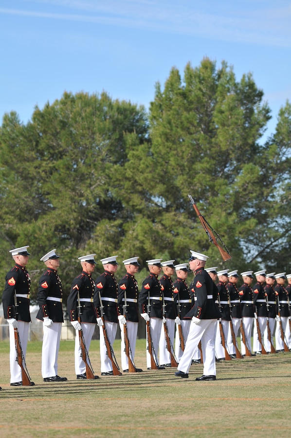 Lance Cpl. Nicholas Meekins, right, Silent Drill Platoon rifle inspector, tosses an M-1 Garand rifle back to Lance Cpl. Chase Pinkerman during a dress rehearsal at the Marine Corps Air Station in Yuma, Ariz., on Feb. 24, 2010. The Marine Corps Battle Color Detachment, made up of the platoon, as well as the Marine Corps Drum and Bugle Corps and the Marine Corps Color Guard, kicked off its annual spring tour in Yuma on Feb. 26-27 with performances on the air station and at two local high schools. Based in Washington, D.C., the Marines spend several weeks rehearsing in Yuma's mild winter each year before touring.