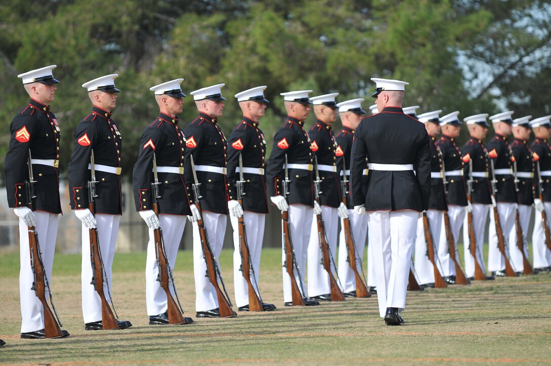 Lance Cpl. Nicholas Meekins, Silent Drill Platoon rifle inspector, marches past the platoon's 24 riflemen during a dress rehearsal at the Marine Corps Air Station in Yuma, Ariz., on Feb. 24, 2010. The Marine Corps Battle Color Detachment, made up of the platoon, as well as the Marine Corps Drum and Bugle Corps and the Marine Corps Color Guard, kicked off its annual spring tour in Yuma on Feb. 26-27 with performances on the air station and at two local high schools. Based in Washington, D.C., the Marines spend several weeks rehearsing in Yuma's mild winter each year before touring.