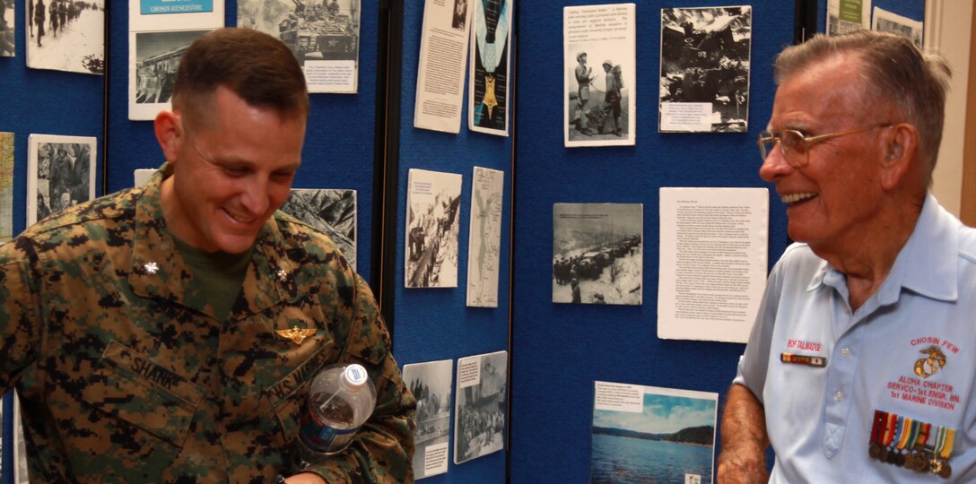 (From left to right) Lt. Col. Milo L. Shank, a helicopter pilot and executive officer for Headquarters and Serve Battalion, U.S. Marine Corps Forces, Pacific, and Retired Master Gunnery Sgt. Robert E. Talmadge, The Chosin Few's Aloha Chapter president, share "a laugh," while exchanging sea stories, Feb. 25 at the Sunset Lanai, Camp H.M. Smith, Hawaii. Talmadge was a supply sergeant with 1st Engineer Battalion, 1st Marine Division, during the Korean War.