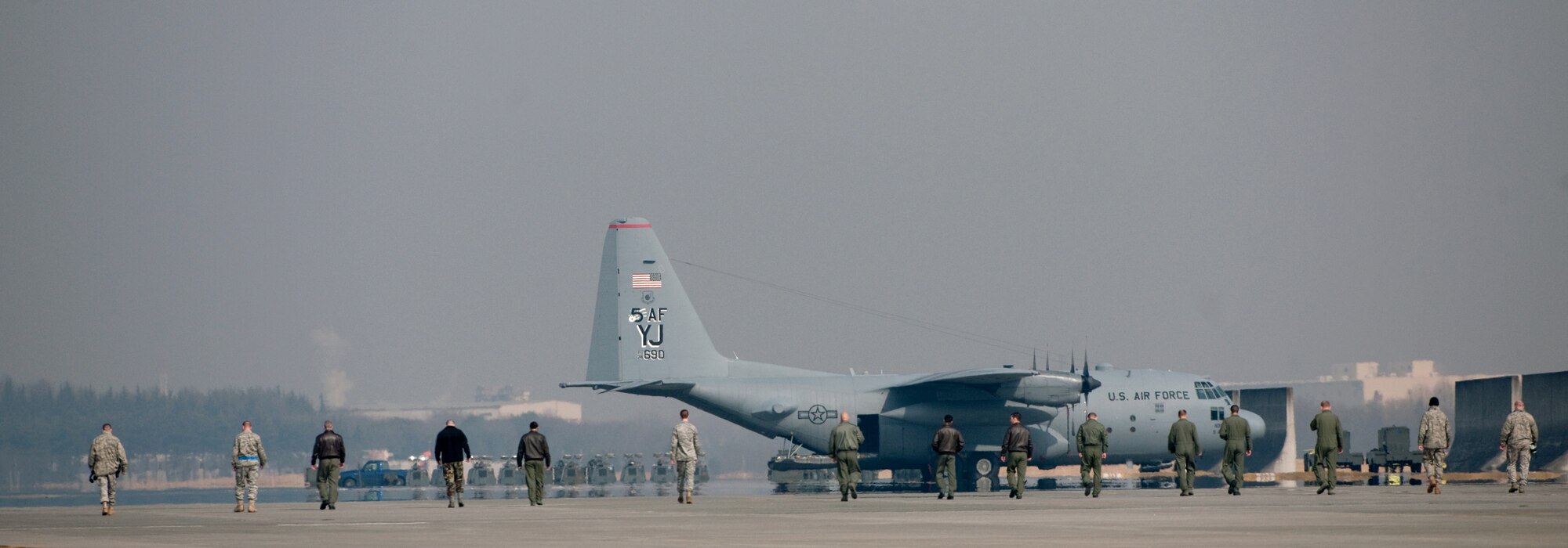 YOKOTA AIR BASE, Japan -- Members of the 36th Airlift Squadron look for Foreign Object Debris (F.O.D.) here, Feb. 23 to minimize the chances of damage to aircraft or injury to personnel on base. (U.S. Air Force photo/Osakabe Yasuo)