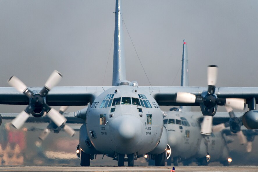 YOKOTA AIR BASE, Japan -- Five C-130 Hercules aircraft line up Feb. 23 before launching as part of a five-aircraft formation flight. (U.S. Air Force photo/Osakabe Yasuo)