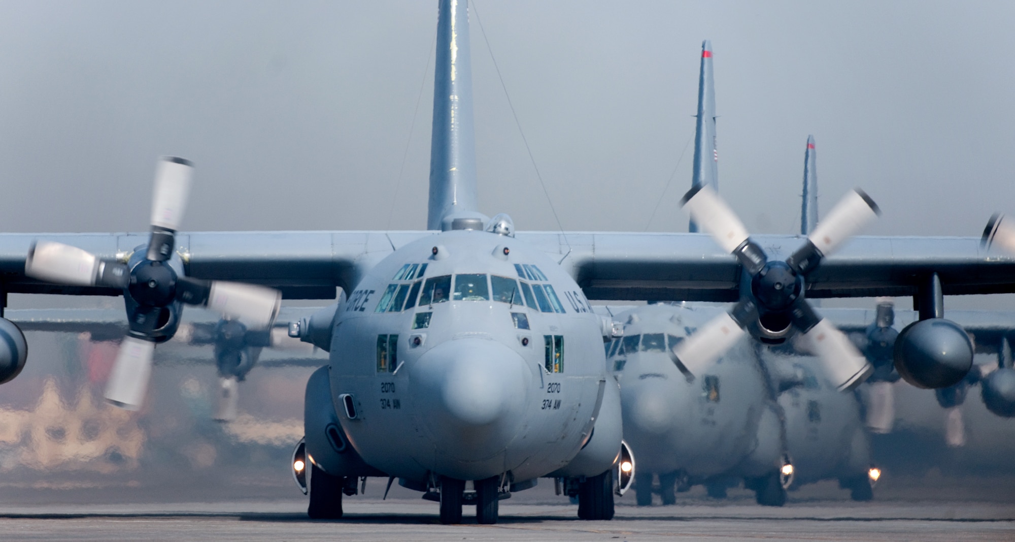 YOKOTA AIR BASE, Japan -- Five C-130 Hercules aircraft line up Feb. 23 before launching as part of a five-aircraft formation flight. (U.S. Air Force photo/Osakabe Yasuo)