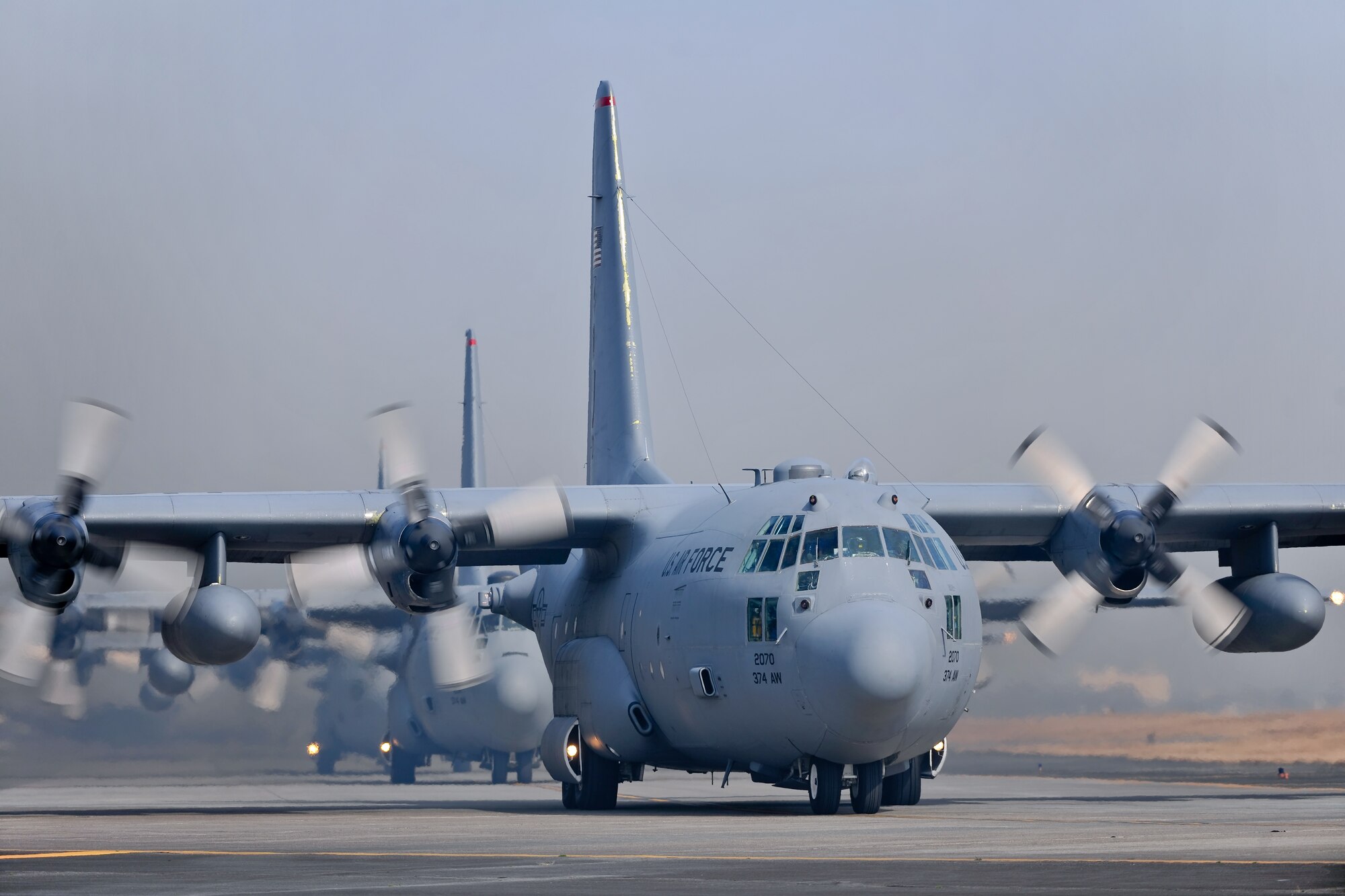 YOKOTA AIR BASE, Japan -- Five C-130 Hercules J aircraft line up Feb. 23 before launching as part of a five-aircraft formation flight. (U.S. Air Force photo/Osakabe Yasuo)