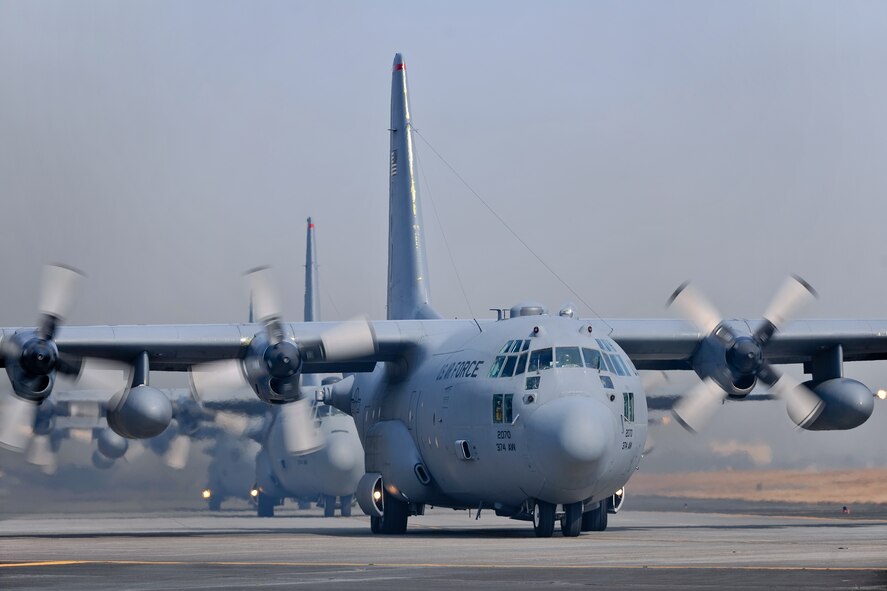 YOKOTA AIR BASE, Japan -- Five C-130 Hercules J aircraft line up Feb. 23 before launching as part of a five-aircraft formation flight. (U.S. Air Force photo/Osakabe Yasuo)