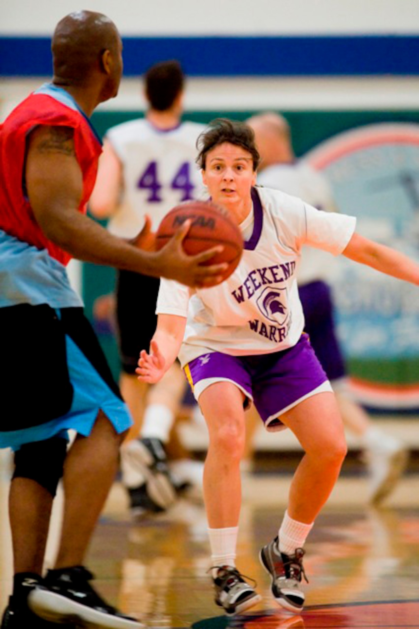 JOINT BASE LEWIS-MCCHORD, Wash.- Warrior guard Heidi Hancockvdefends Horseman forward George "Tony" Brown during a 30-and-over intramural basketball game at the JBLM Fitness Center Feb. 24. The Warriors dominated the Horsemen 72-40. (U.S. Air Force Photo/Abner Guzman)