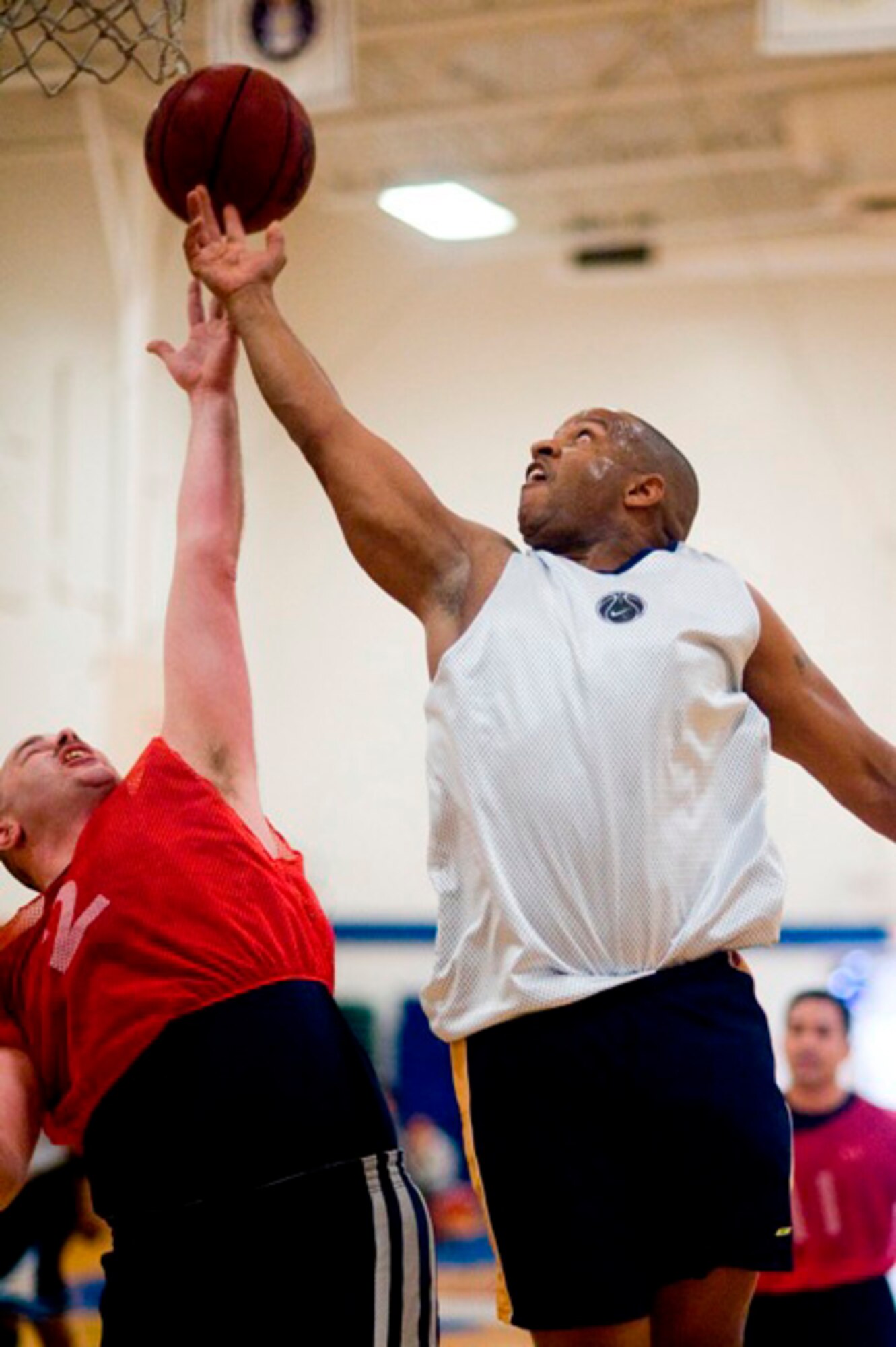JOINT BASE LEWIS-MCCHORD, Wash.-bWarrior forward Derek Bryant gets the upperhand on a rebound over Horseman forward Richard Vance, during a 30-and-over intramural basketball game at the JBLM Fitness Center Feb. 24. The "Weekend Warriors" are the Reserve team of the league. Bryant scored 14 points in the Warriors 72-40 victory over the Horsemen. (U.S. Air Force Photo/Abner Guzman)