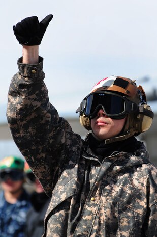 NELLIS AIR FORCE BASE, Nev. -- Petty Officer3rd Class, aviation structural mechanic Bryan Shishido, Tactical Electronic Warfare Squadron  One Three Nine (VAQ-139) from Whidbey Island, Wash. signals to the aircrew of a EA-6B Prowler during aircraft checks at Red Flag 10-3 Feb. 23, 2010.  Red Flag is a realistic combat training exercise involving the air forces of the United States and its allies. The exercise is conducted on the 15,000-square-mile Nevada Test and Training Range, north of Las Vegas.  (U.S. Air Force Photo by Staff Sgt. William P. Coleman/RELEASED)