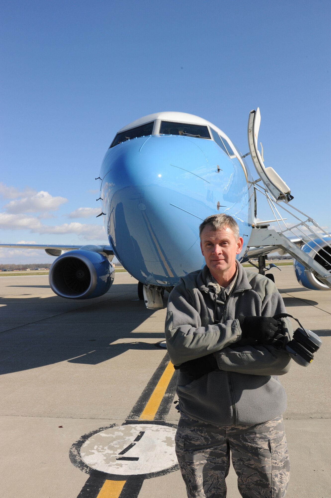 932nd Maintenance Group personnel take care of the C-40C plane at Scott Air Force Base.  The Air Force Reserve Command unit has three of the aircraft.  Master Sgt. Peter VanTol, flying crew chief, prepares to launch the blue, white and gold plane on a cold, blustery, Illinois day.  (U.S. Air Force photo/Maj. Stan Paregien)