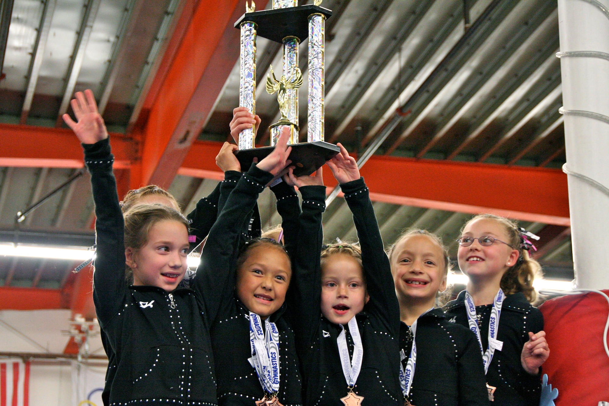 CAMARILLO, Calif. -- The Vandenberg Youth Programs Jets girls gymnastics Level 4 team receives their First Place Team trophy at the Snowflake Classic gymnastics competition Feb. 6 here. The Jets, coached by Allison Pledger under the direction of Lee Pledger, range in age from 6 - 10 years old. (Photo by Cheryl Castellenos)