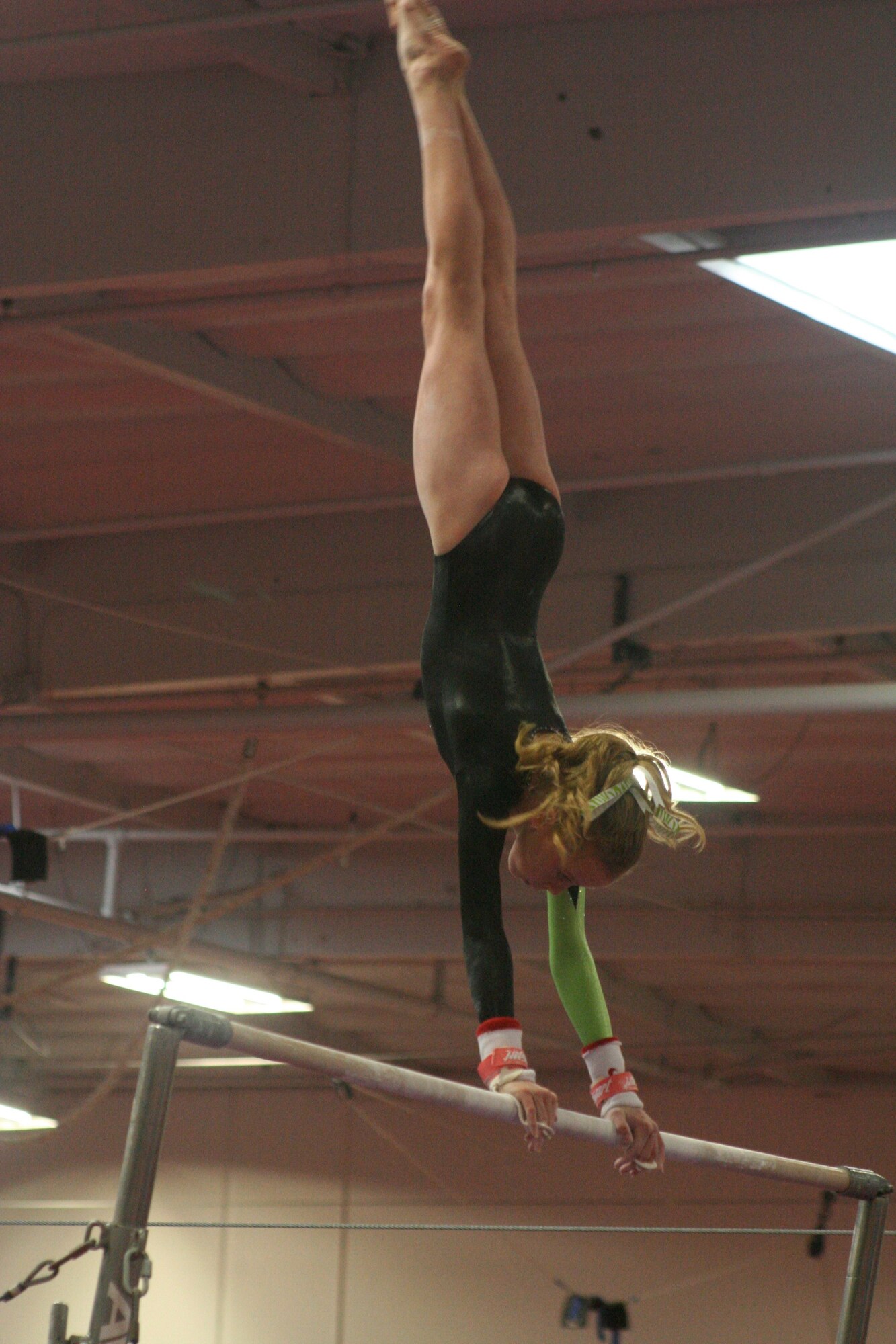 CAMARILLO, Calif. -- Ashley Castellenos, age 13, performs a handstand during her bar routine at the Snowflake Classic gymnastics competition Feb. 7 here. Castellenos, who is with the Vandenberg Youth Programs Jets girls gymnastics Level 7 team, placed third on the bar, third on the beam and fourth all around. (Photo by Cheryl Castellenos)
