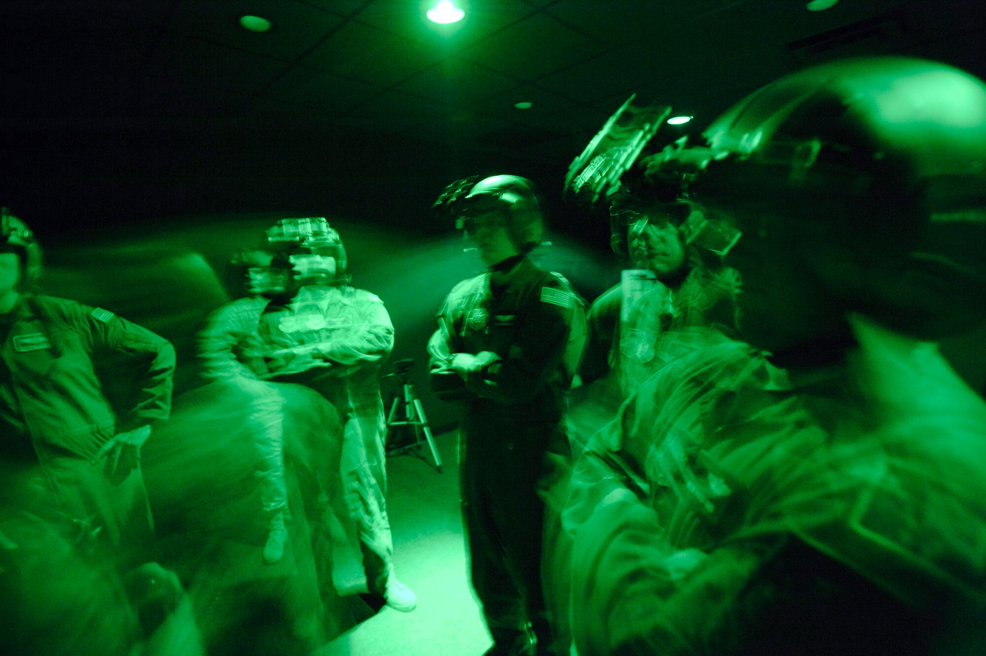 Students of the Night Vision Goggle Academic Instructor course at Randolph Air Force Base, Texas, viewed through NVGs, get practical experience adjusting and wearing their NVGs. (U.S. Air Force photo by Steve Thurow)