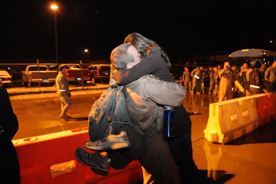 DYESS AIR FORCE BASE, Texas -- Dana Boeckman, wife of Capt. Scott Boeckman, jumps into her husband’s arms. Captain Boeckman, 317th Airlift Group, was deployed to Southwest Asia in support of Overseas Contingencies Operation. He was gone for four months. (U.S Air Force photo by Airman 1st Class Shannon Hall)