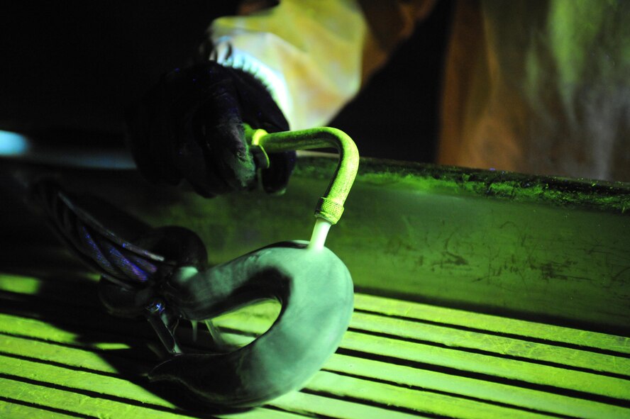ELLSWORTH AIR FORCE BASE S.D.--  Airman 1st Class Luis Garrigas, 28th Maintenance Squadron non-destructive inspection journeyman, performs a magnetic particle inspection to search for any defects on a wire rope hook, Feb. 25. Aircraft maintainers rely on nondestructive inspection technicians to ensure military aviation equipment safety. (U.S. Air Force photo/Airman 1st Class Corey Hook)
