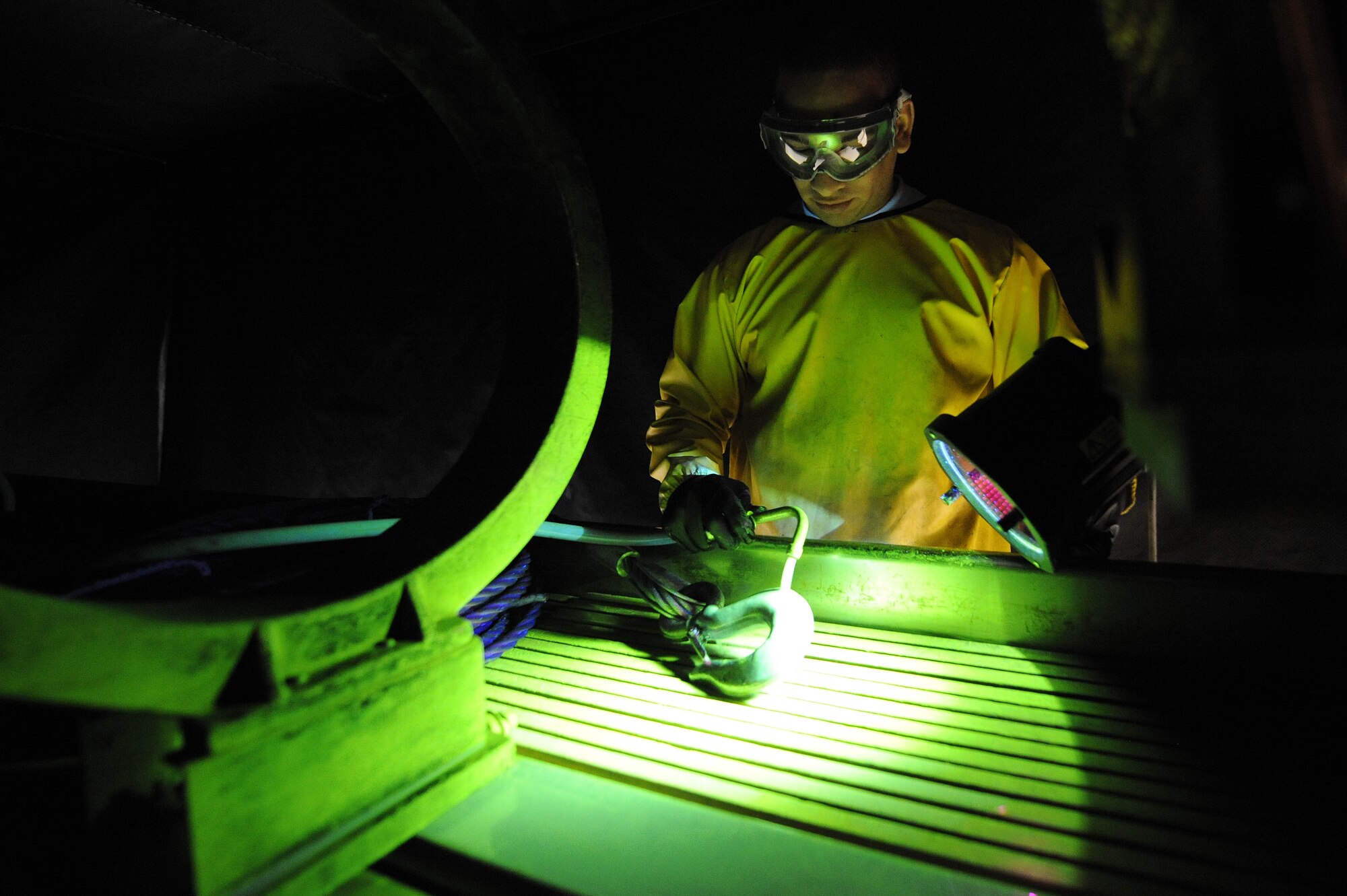 ELLSWORTH AIR FORCE BASE S.D.--  Airman 1st Class Luis Garrigas, 28th Maintenance Squadron non-destructive inspection journeyman, performs a magnetic particle inspection to search for any defects on a wire rope hook, Feb. 25.  Airman Garrigas detects flaws, such as cracks, and then interprets the results for the repair center. (U.S. Air Force photo/Airman 1st Class Corey Hook)