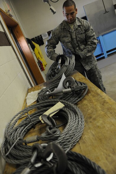 ELLSWORTH AIR FORCE BASE S.D.--  Airman 1st Class Luis Garrigas, 28th Maintenance Squadron non-destructive inspection journeyman, inspects a wire rope hook, Feb. 25. Airman Garrigas detects flaws, such as cracks, and then interprets the results for the repair center. (U.S. Air Force photo/Airman 1st Class Corey Hook)