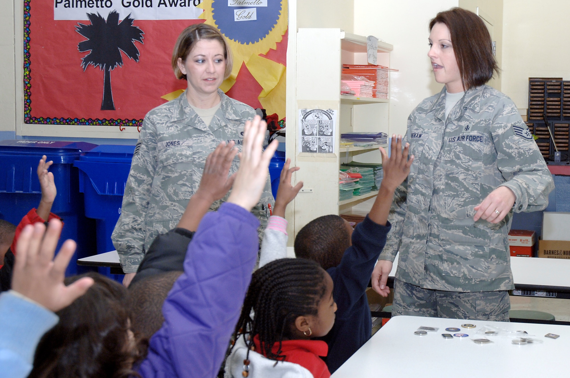 Staff Sgts. Patricia Jones, left, and Laci Brokaw answer questions from  kindergarten students at Stono Park Elementary regarding their Air Force jobs during the school's career day Feb. 24, 2010, in Charleston, S.C. Volunteers from Joint Base Charleston went out to speak to the students on what it is like to be in the Air Force and how important it is for the kids to stay in school. Sergeant Jones is the 437th Airlift Wing command chief's executive assistant and Sergeant Brokaw is the 628th Air Base Wing command chief's executive assistant. (U.S. Air Force photo/Staff Sgt. Marie Brown)