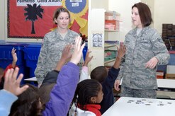 Staff Sgts. Patricia Jones, left, and Laci Brokaw answer questions from  kindergarten students at Stono Park Elementary regarding their Air Force jobs during the school's career day Feb. 24, 2010, in Charleston, S.C. Volunteers from Joint Base Charleston went out to speak to the students on what it is like to be in the Air Force and how important it is for the kids to stay in school. Sergeant Jones is the 437th Airlift Wing command chief's executive assistant and Sergeant Brokaw is the 628th Air Base Wing command chief's executive assistant. (U.S. Air Force photo/Staff Sgt. Marie Brown)